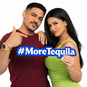 A couple holding a large #MoreTequila Prop, showcasing its fun design in a vibrant photo.