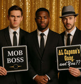Three men in suits holding mob-themed photo booth props, including 'MOB BOSS' and 'AL Capone's Gang' signs.