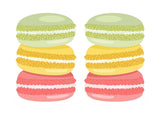 Colorful stacked macarons in green, yellow, and pink, showcasing a delightful assortment of sweets.