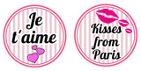 Colorful round party props featuring "Je t'aime" and "Kisses from Paris" designs, perfect for a Paris-themed celebration.