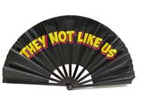 They Not Like Us Folding Fan for Photo Booth Party - colorful 13" fan prop for events and photo booths.
